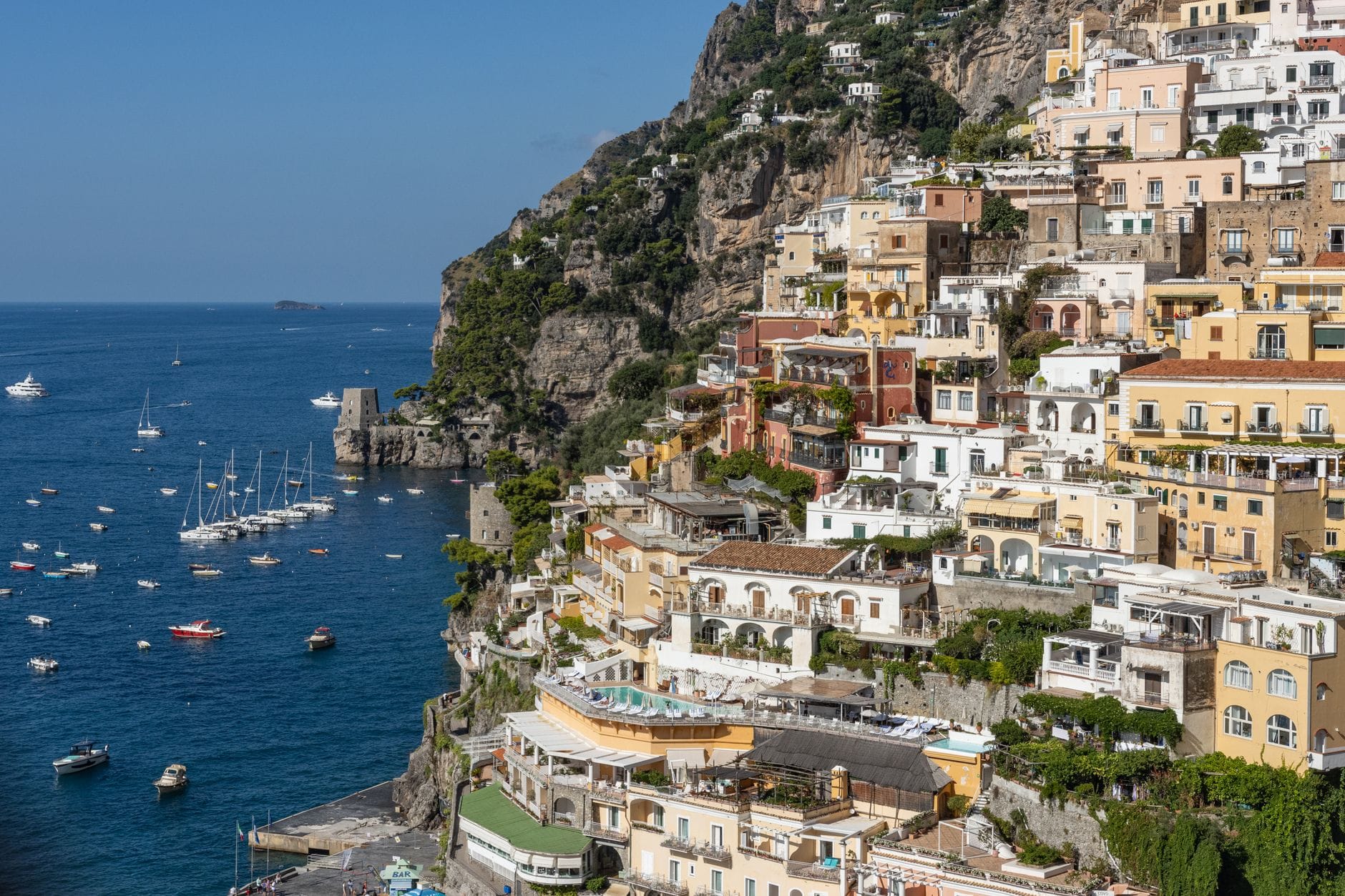 Stunning aerial view of Positano's colorful hillside buildings and azure sea in Italy.